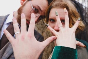 Close-up wedding ring photo with playful couple interaction during Atlanta wedding